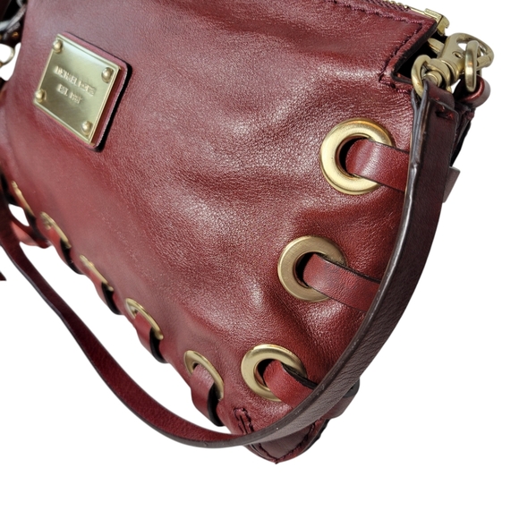 Michael Kors red leather clutch with grommets and tassels